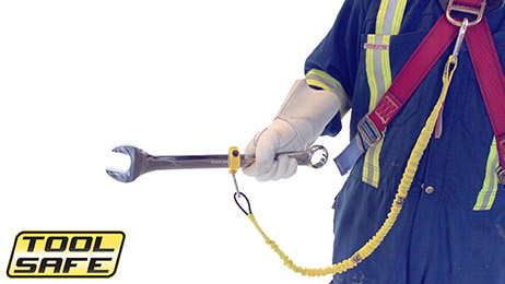 Man holding wrench with ToolSafe® Clamp and Harness Lanyard.