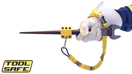Man holding large wrench with ToolSafe® Press Block and Wrist Lanyard.